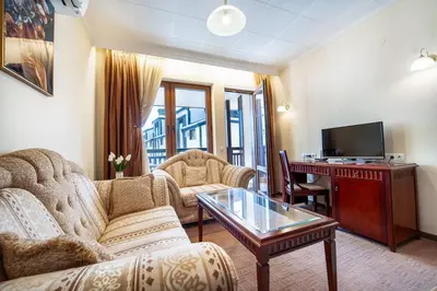a living room with a couch and a table at Ski Lift Delight Bansko Apartment in Bansko