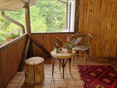 a porch with a table and chairs and a window at Vila Anna in Ribarica