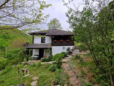 a small white house with a black roof at Vila Anna in Ribarica