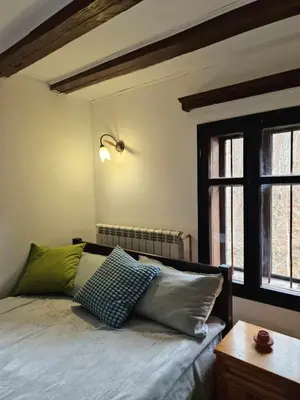 a bedroom with a bed with two pillows on it at Vila Anna in Ribarica