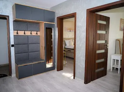 a room with a closet and a bedroom with a bed at КЪЩА ЗА ГОСТИ ГРОШЪ in Dobrinishte