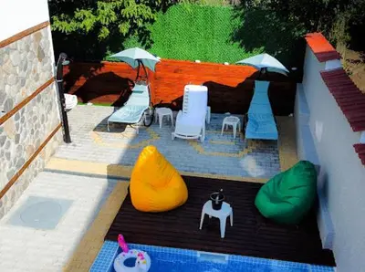 a model of a backyard with a table and chairs at КЪЩА ЗА ГОСТИ ГРОШЪ in Dobrinishte