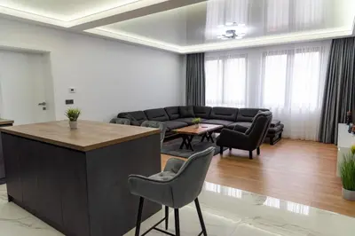a living room with a couch and a table and chairs at A-Dent luxury apartments & Dental Clinic in Gotse Delchev