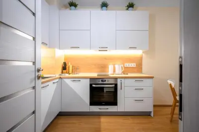 a kitchen with white cabinets and a stove at Bright and Cosy 1BD Flat - Perfect for Business Trip by Flat Mаnager in Sofia