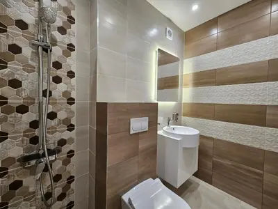 a bathroom with a toilet sink and a shower at Villa Geronimo in Bansko