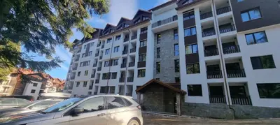 a white car parked in front of a building at Borovets gardens Studio A12 in Borovets