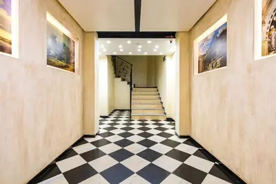 a hallway with a black and white checkered floor at Spacious Central Apt by Stefanie / close to MU in Plovdiv
