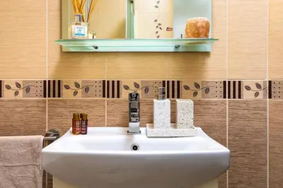 a bathroom with a white sink and a mirror at Spacious Central Apt by Stefanie / close to MU in Plovdiv