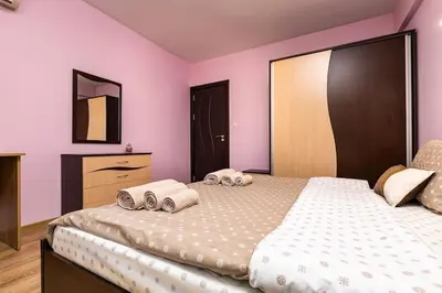 a bedroom with a large bed with towels on it at Spacious Central Apt by Stefanie / close to MU in Plovdiv