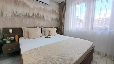 a bedroom with a large bed and a window at Very cozy and comfort house in top location in Bansko