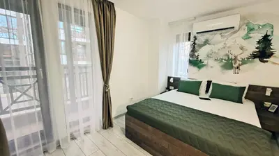 a bedroom with a bed and a large window at Very cozy and comfort house in top location in Bansko