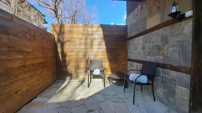 a patio with two chairs and a table at Very cozy and comfort house in top location in Bansko