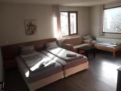 a living room with two beds and a couch at Dariya Guest House in Sapareva Banya