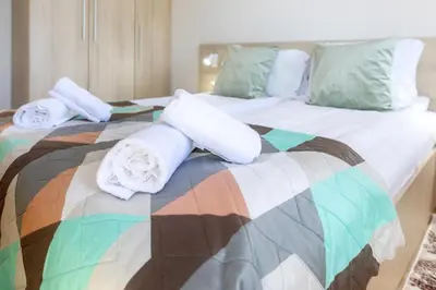 a large bed with towels on top of it at Mountain Escape & View & Relax in Bansko