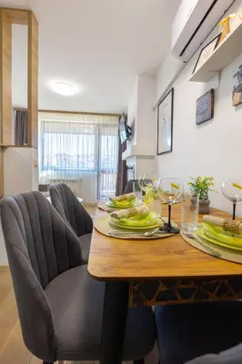 a dining room with a wooden table and chairs at Mountain Escape & View & Relax in Bansko