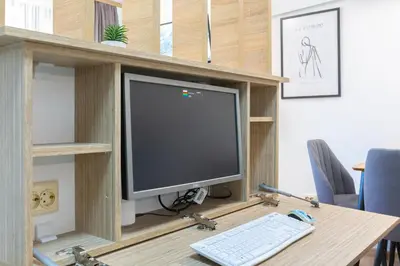 a computer monitor on a wooden desk with a keyboard at Mountain Escape & View & Relax in Bansko