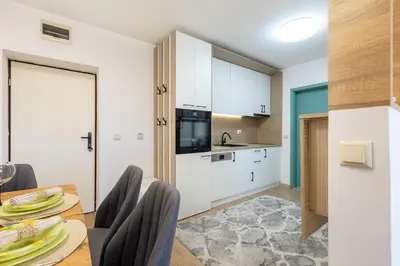 a kitchen and dining room with a table and chairs at Mountain Escape & View & Relax in Bansko
