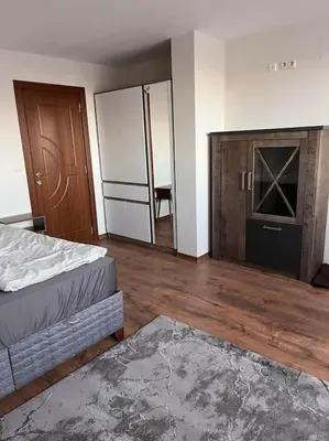 an empty room with two beds and a tv at Двуспален апартамент в к-с Пирин Палас in Bansko