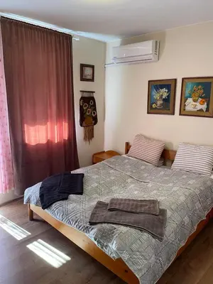 a bedroom with a large bed and a window at NiDo Cozy 3BR Apartment Kapana Top Center in Plovdiv