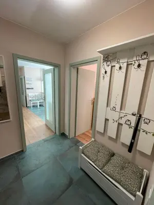 a living room with a couch and a mirror at NiDo Cozy 3BR Apartment Kapana Top Center in Plovdiv