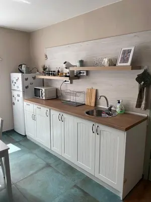 a kitchen with a sink and a white refrigerator at NiDo Cozy 3BR Apartment Kapana Top Center in Plovdiv