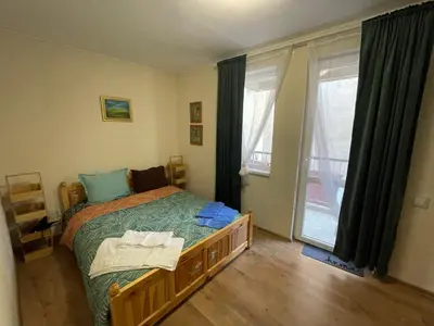 a bedroom with a bed and a large window at NiDo Cozy 3BR Apartment Kapana Top Center in Plovdiv