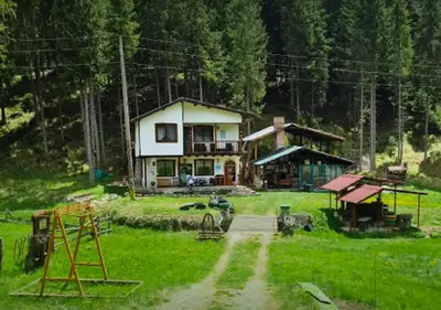 a small house in the middle of a field at ВИЛА ПЕРИКА-Vila PERIKA in Borino