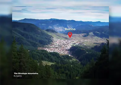 a view of a town in a valley with a red marker at ВИЛА ПЕРИКА-Vila PERIKA in Borino