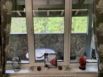 a window with views of a stone wall at 705 in The Stream Resort in Pamporovo