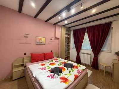 a bedroom with a large bed with flowers on it at The Maisonette in Sofia's Heart in Sofia