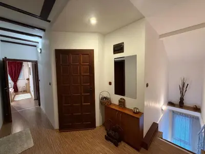 a hallway with a wooden door and a mirror at The Maisonette in Sofia's Heart in Sofia