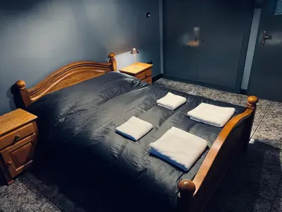 a bedroom with a bed with two towels on it at Central Apartment Black Cat in Karlovo