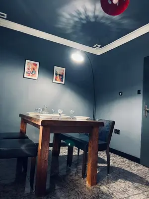a table in a room with two chairs and a lamp at Central Apartment Black Cat in Karlovo