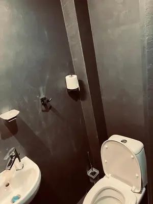 a bathroom with a toilet and a sink at Central Apartment Black Cat in Karlovo