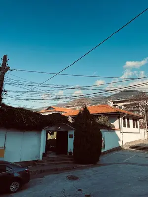 a house with a car parked in front of it at Central Apartment Black Cat in Karlovo