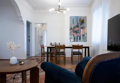 a living room with a table and chairs at Bohemian Central Apartment Sofia in Sofia
