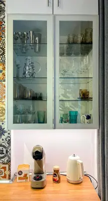 a kitchen cabinet filled with lots of dishes at Bohemian Central Apartment Sofia in Sofia