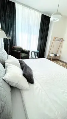 a large white bed with two pillows in a bedroom at Bohemian Central Apartment Sofia in Sofia