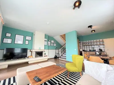 a living room with a couch and a tv at Private Villa in Ruskovets in Dobrinishte