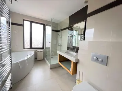 a bathroom with a tub and a sink and a toilet at Private Villa in Ruskovets in Dobrinishte