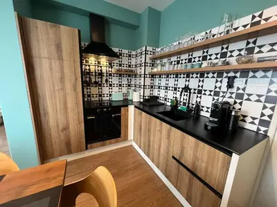a kitchen with black and white tiles on the wall at Private Villa in Ruskovets in Dobrinishte