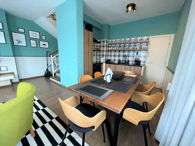 a dining room with a wooden table and chairs at Private Villa in Ruskovets in Dobrinishte