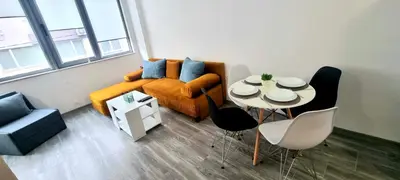 a living room with a couch and a table at Flower home 11 in Sofia