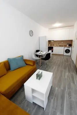 a living room with a couch and a table at Flower home 11 in Sofia