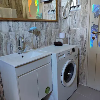 a bathroom with a washing machine and a sink at INSTA Haus in Plovdiv