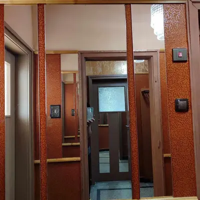 a reflection of a door in a mirror in a building at INSTA Haus in Plovdiv