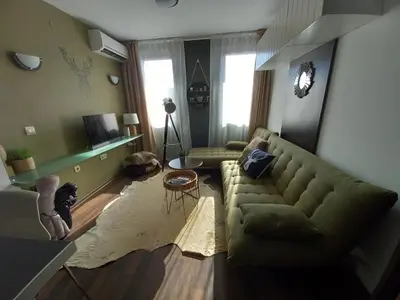 a living room with a couch and a table at Top Top location Green apartment in Bansko