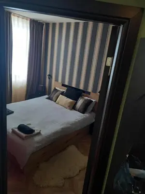 a mirror reflection of a bed in a bedroom at Top Top location Green apartment in Bansko