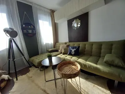 a living room with a green couch and a table at Top Top location Green apartment in Bansko