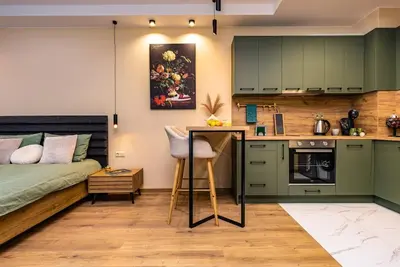 a kitchen with green cabinets and a bed in a room at Green Hills Plovdiv close to Medical University in Plovdiv